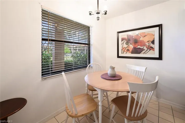 Tiled dining space featuring baseboards