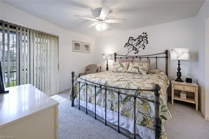 Bedroom with light carpet and a ceiling fan