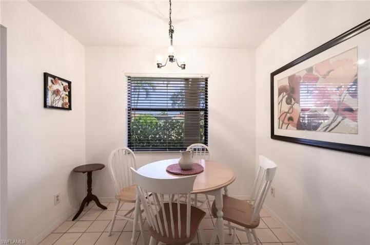 Dining area featuring light tile patterned floors and a chandelier