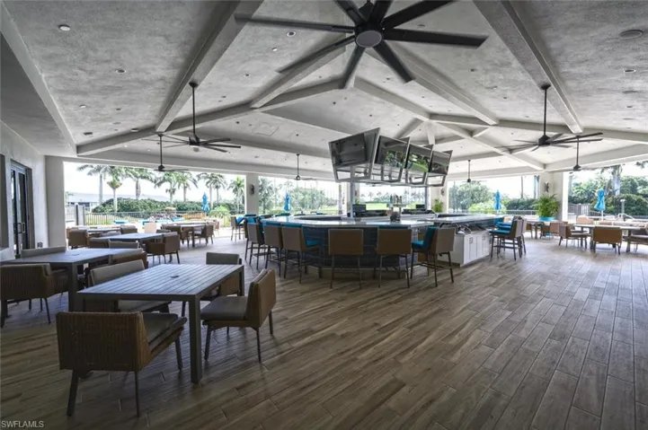 Dining space featuring dark wood-type flooring and ceiling fan
