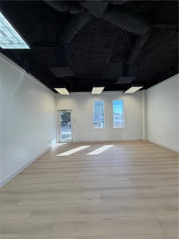 Spare room featuring light wood finished floors and baseboards