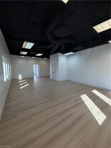 Basement featuring light wood-style floors and ornamental molding