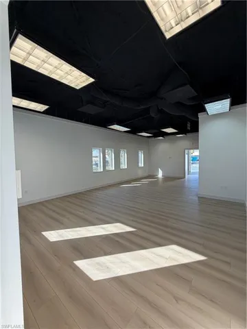 Unfurnished room featuring light wood-style floors and baseboards