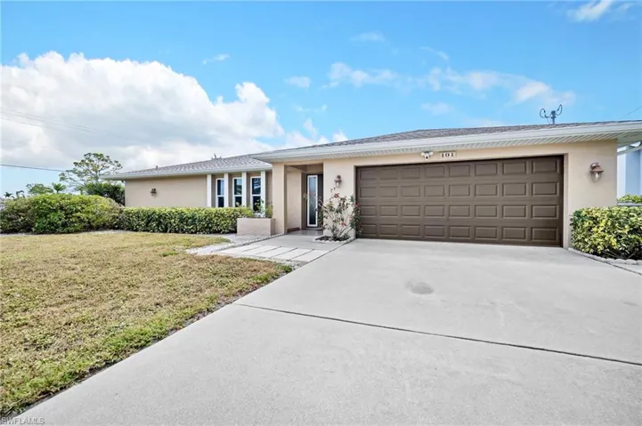 Single story home featuring stucco siding, driveway, a garage, and a front yard