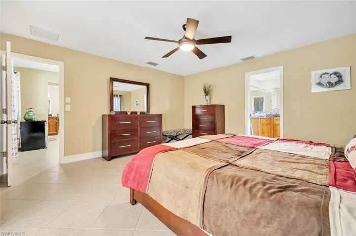 Bedroom featuring baseboards, visible vents, and light tile patterned floors