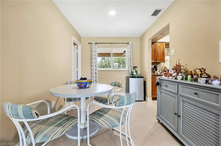 Dining area with light tile patterned flooring and visible vents