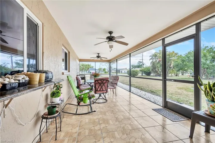 Sunroom with visible vents, outdoor dining area, and ceiling fan