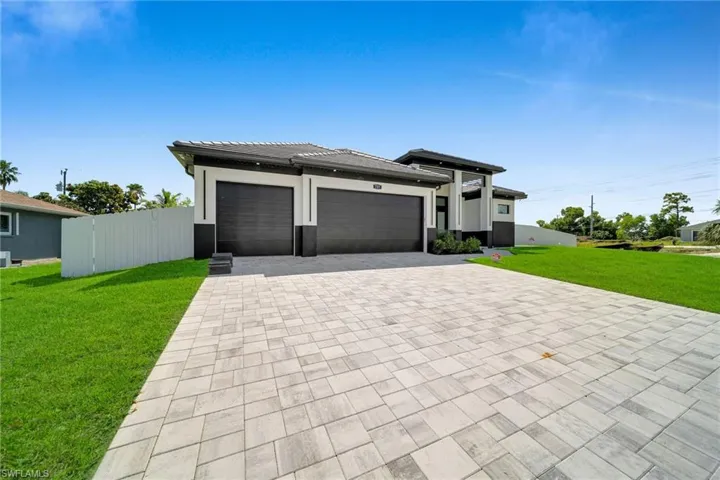 Prairie-style home featuring a front lawn and a garage