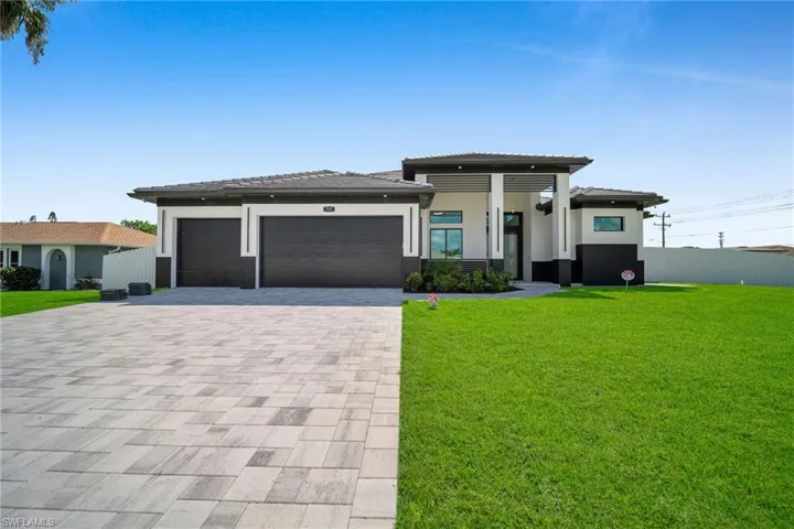 Prairie-style house with a garage and a front lawn