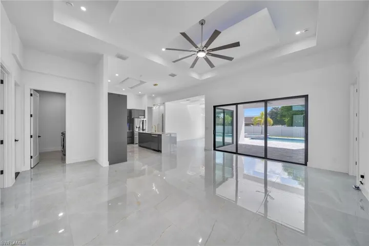 Empty room with a tray ceiling and ceiling fan