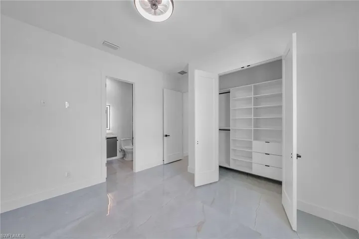 Unfurnished bedroom featuring ensuite bath