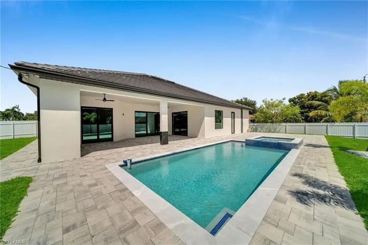 View of swimming pool with ceiling fan and a patio