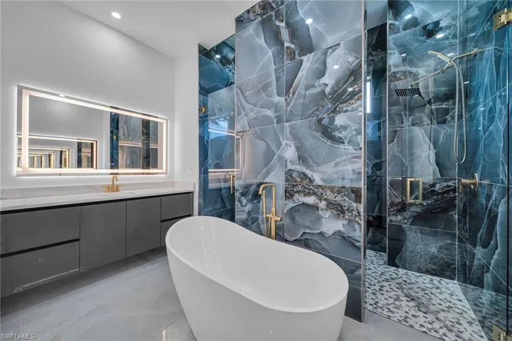 Bathroom featuring vanity and plus walk in shower