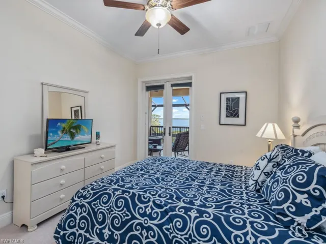Bedroom featuring ceiling fan, light colored carpet, ornamental molding, and access to outside