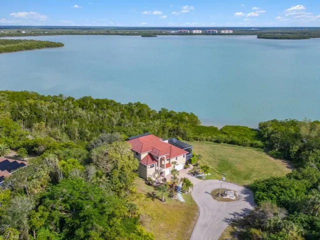 Birds eye view of property with a water view