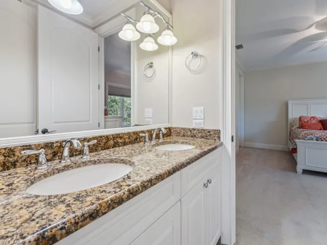 Bathroom featuring crown molding, vanity, and ceiling fan