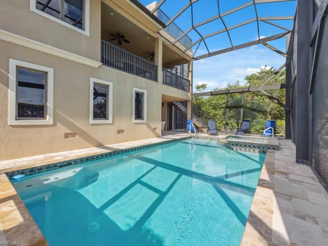 View of swimming pool featuring an in ground hot tub, a patio, glass enclosure, and ceiling fan