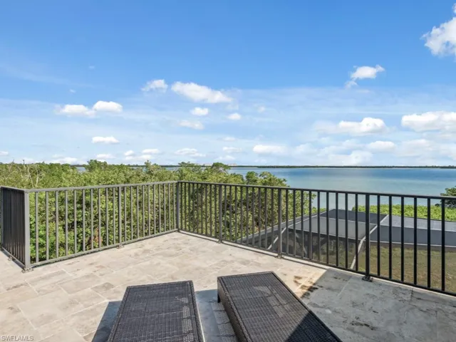 View of patio featuring a water view and a balcony