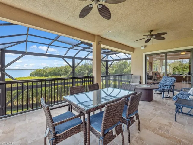View of patio with glass enclosure and ceiling fan