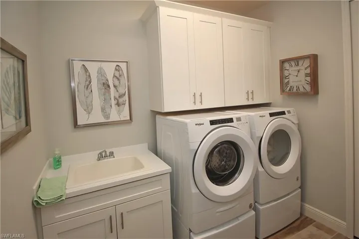 Large Laundry Room with Closet and Cabinets