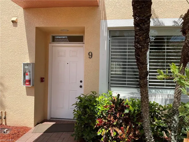 Doorway to property with stucco siding