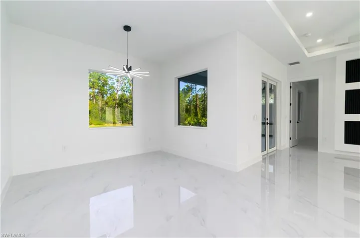 Unfurnished room featuring light marble finish floors and recessed lighting