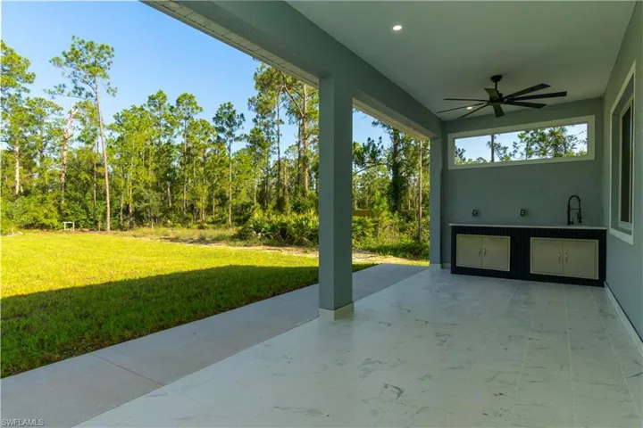 View of patio with ceiling fan and a sink