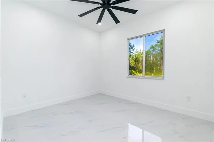 Empty room with light marble finish flooring, a ceiling fan, and recessed lighting