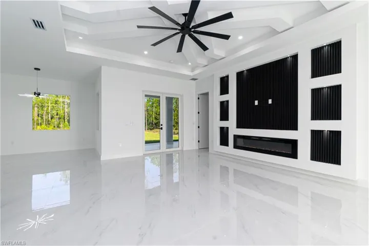 Unfurnished room featuring light marble finish floors, a ceiling fan, french doors, coffered ceiling, and recessed lighting