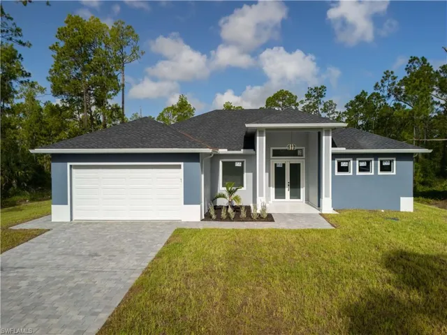 View of front of property featuring french doors, a garage, a shingled roof, stucco siding, and decorative driveway