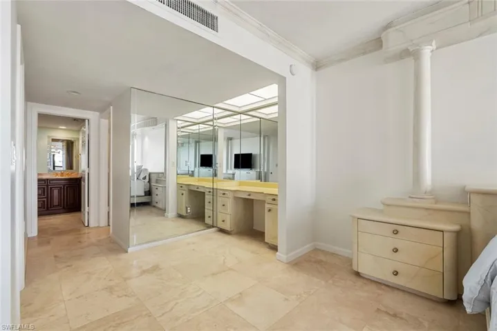Bathroom with vanity, decorative columns, and crown molding