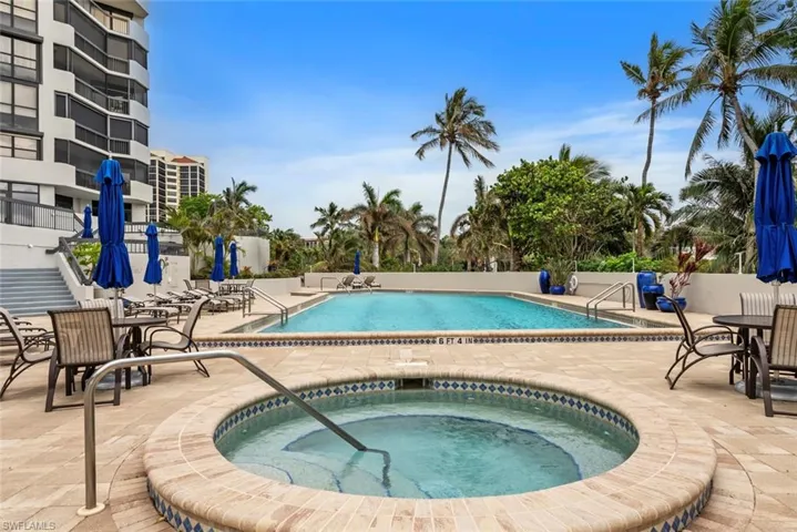 View of swimming pool featuring a patio area and a hot tub