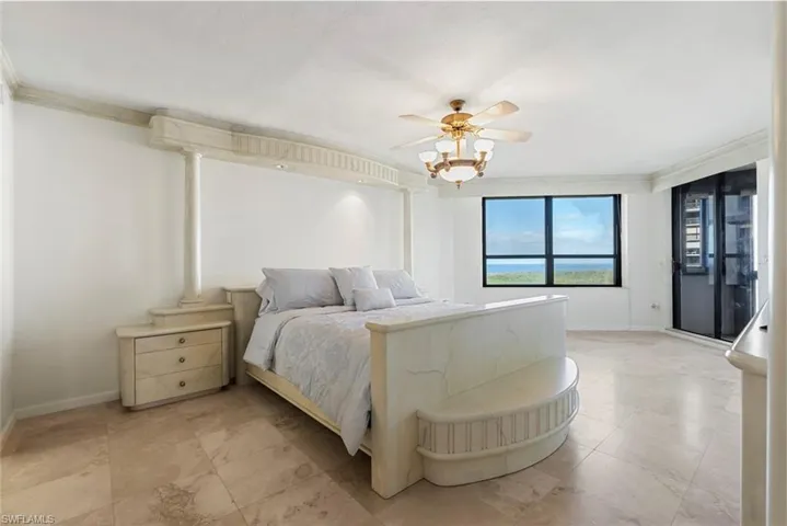 Bedroom featuring ceiling fan and crown molding