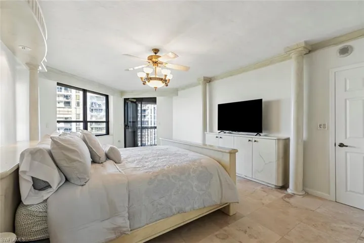 Bedroom with ceiling fan and crown molding