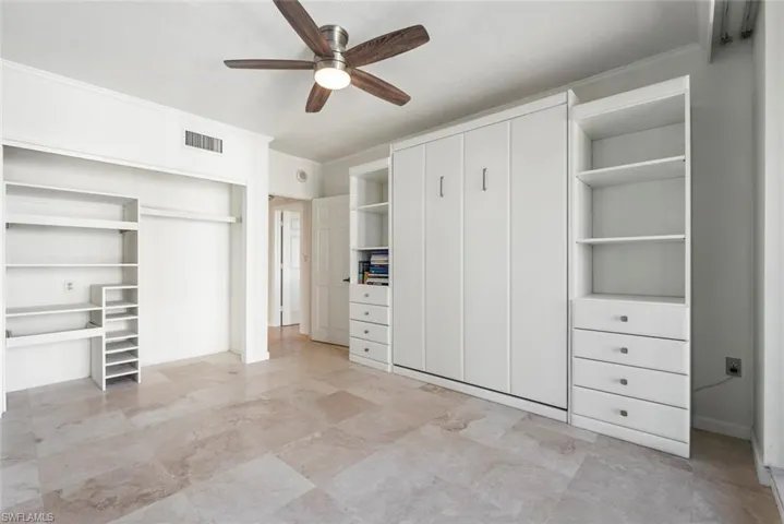 Unfurnished bedroom featuring ceiling fan and crown molding