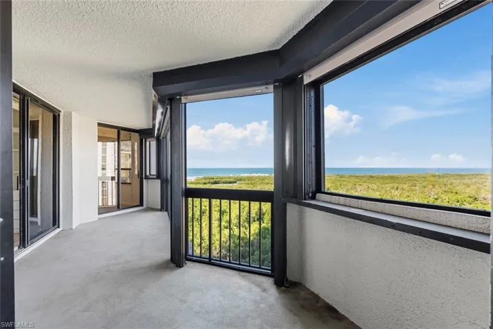 Unfurnished sunroom featuring a water view