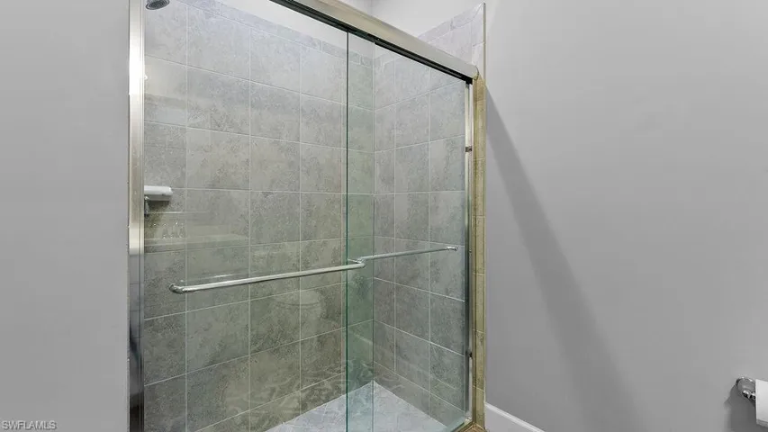 Bathroom with a shower with door