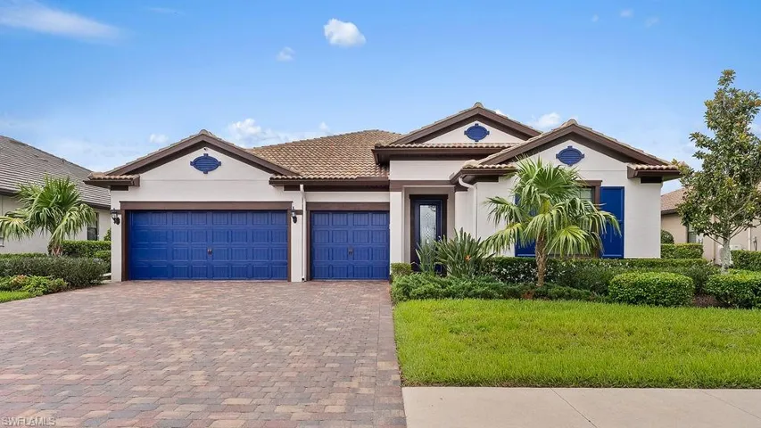Mediterranean / spanish-style house with a garage and a front yard