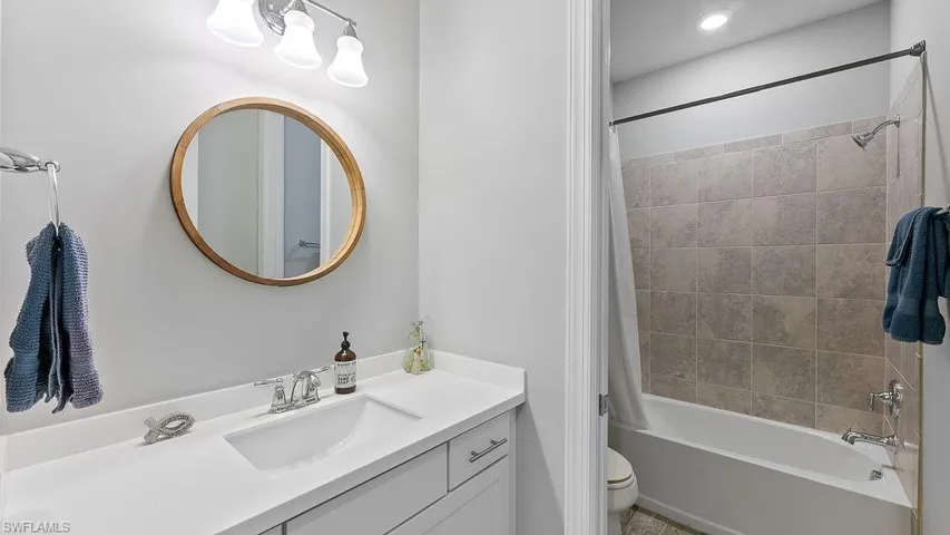 Full bathroom featuring shower / tub combo, toilet, and vanity