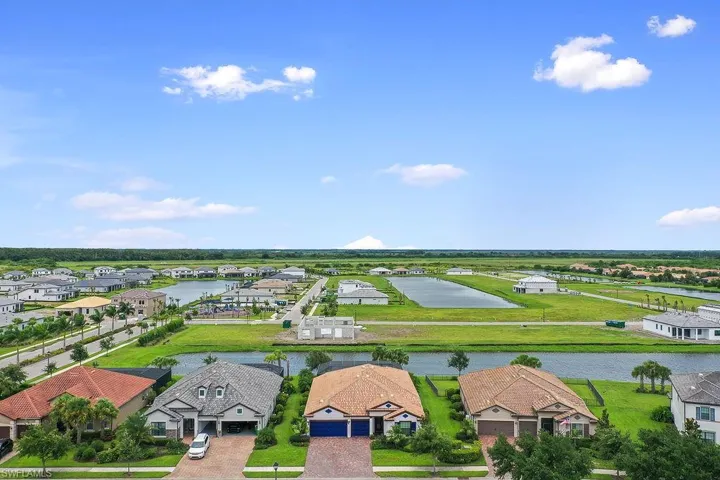 Birds eye view of property with a water view