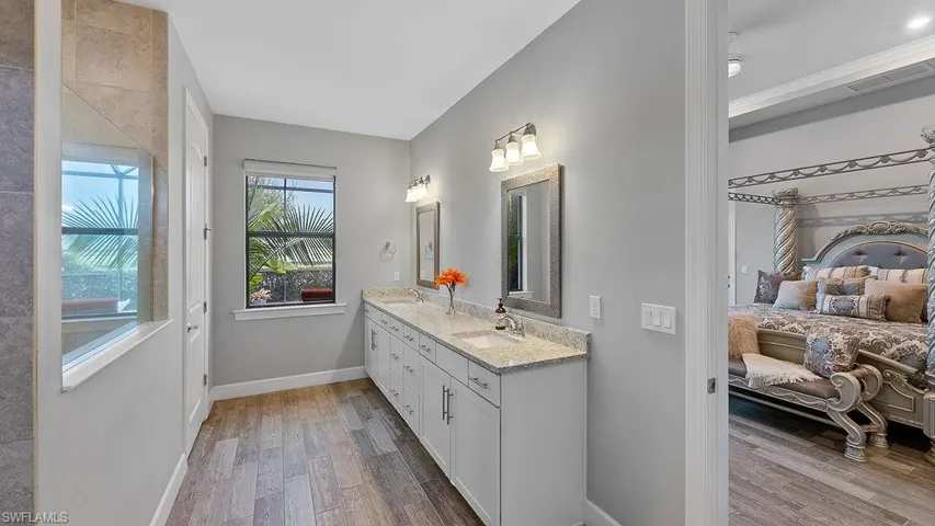 Bathroom with hardwood / wood-style flooring and double vanity