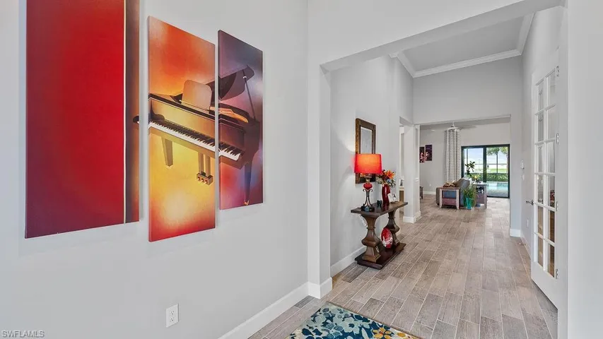 Hall featuring crown molding, light wood-type flooring, and french doors