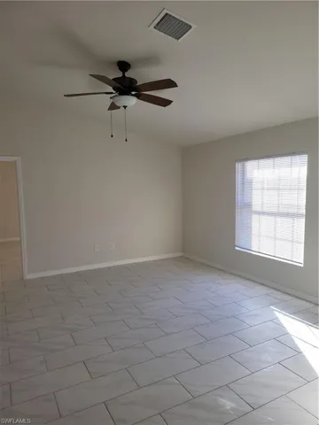 Spare room with baseboards and ceiling fan