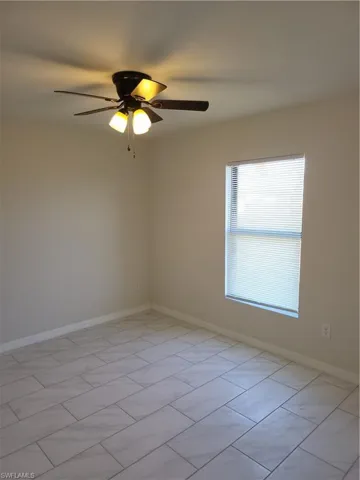 Empty room featuring baseboards