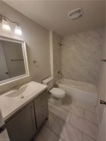 Full bathroom with shower / washtub combination and vanity