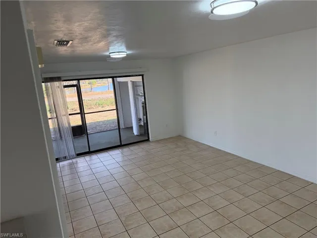 Empty room featuring light tile patterned floors
