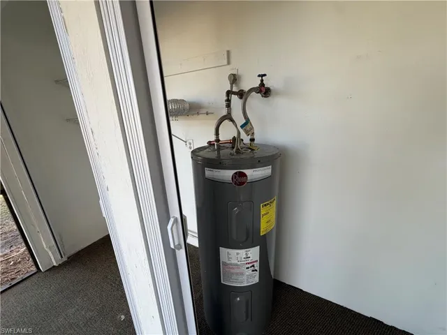 Utility room featuring electric water heater