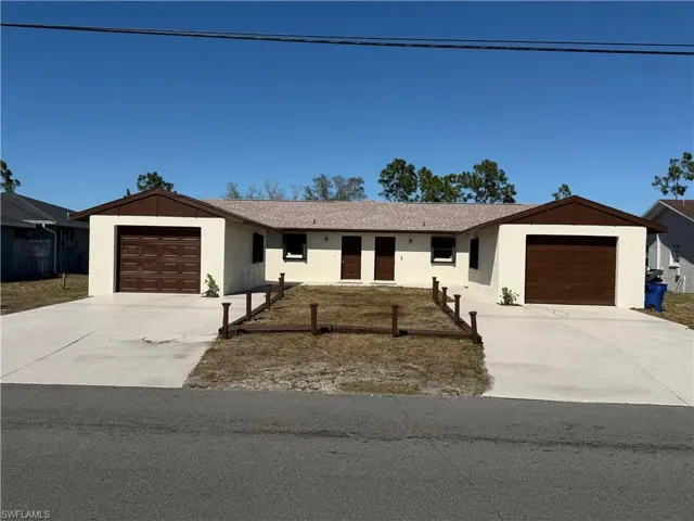 Ranch-style home with a garage, stucco siding, and concrete driveway