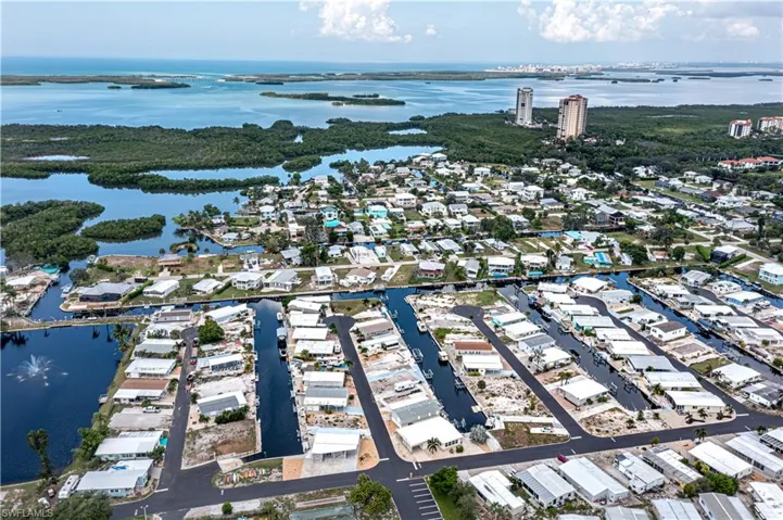 Aerial overview of property's location with a nearby body of water and nearby suburban area