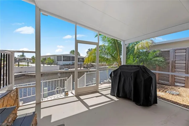 Sunroom / solarium featuring a water view